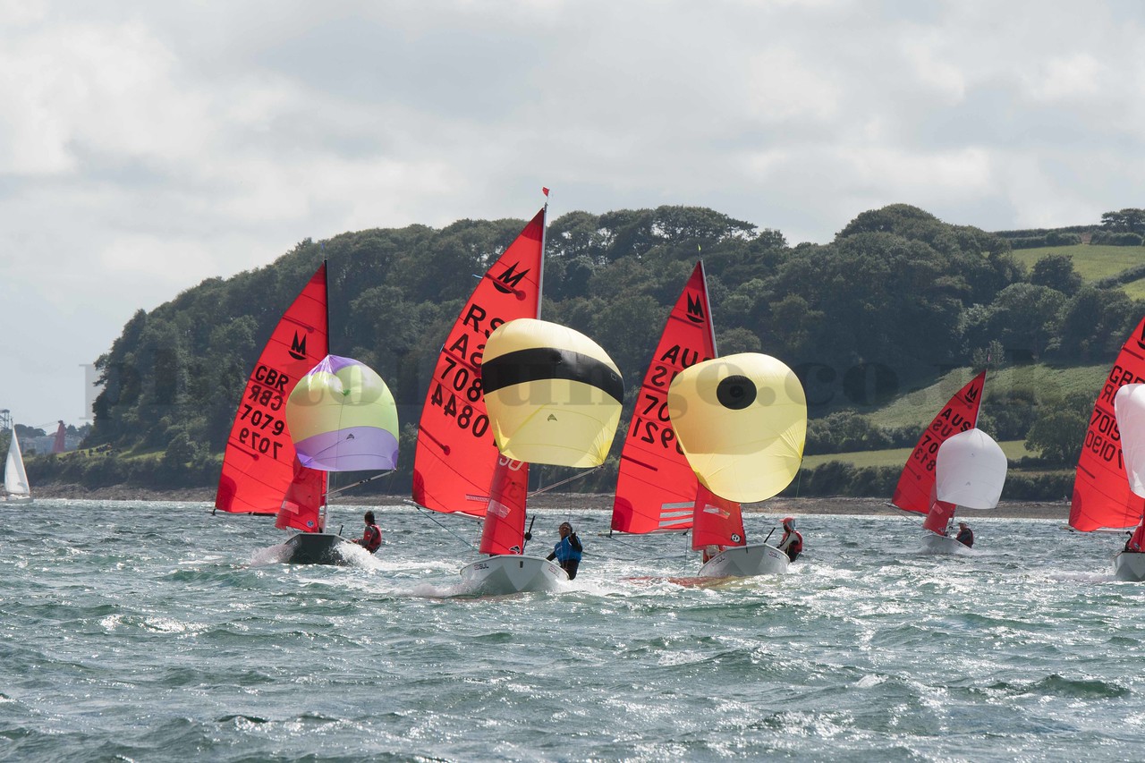 Mirror dinghies racing on a run with spinnakers flying